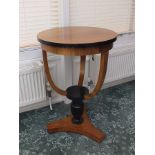 A 20th century satinwood veneered occasional table of Biedermeier design, the circular top with