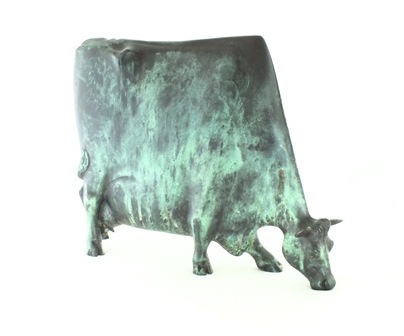 A bronze figure of a cow standing four square, it's head turned licking its back, green - Image 3 of 4