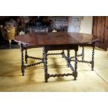 A late 17th century oak oval gateleg dining table, the plank top, plain rectangular frieze, on