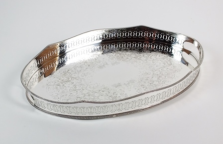 An oval silver plated gallery tray, with central bright cut engraved foliate decoration and