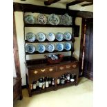 An 18th century oak high dresser, the superstructure with moulded cornice, undulating frieze, four