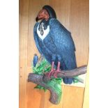 A late 20th century carved and painted wood Vulture, perched on a branch, with another Vulture in