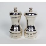 A pair of silver mounted salt and pepper grinders, JB Ltd, London 1990, of plain polished waisted