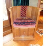 A craftsman made oak low back sedile chair of Medieval design, panelled construction with moulded