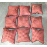 Nine cushions, each having terracotta and gold check fabric with piped edges