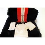 A crimson, white and black stripe table runner, damask and other napkins