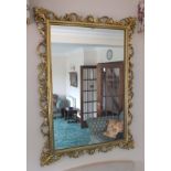 A late 20th century decorative gilt framed wall mirror with acanthus leaf decoration, plate size