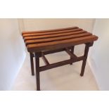 A hardwood slatted top stool, raised on square ribbed supports with cross stretchers, 60cm wide