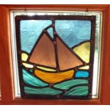 A 20th century leaded stained glass panel depicting a sailing ship at sea, 25.5cm by 23cm