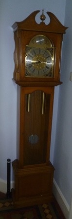 A modern oak finished longcase clock, with brass dial and silvered chapter ring, bearing the
