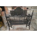 A 19th century iron fire grate, to the front a standing 19th century iron guard with pair of