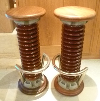 A pair of bar stools assembled from glazed ceramic and metal coils from a power station, with