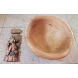 A rustic hewn wooden bowl, together with a carved wooden wall hanging depicting a native female with