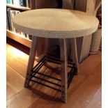 A contemporary nautical themed occasional table with ropework finished circular top, raised on