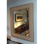 A large modern wall mirrror of rectangular form, in a fabric covered cushion moulded frame, 94cm
