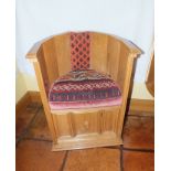 A craftsman made oak low back sedile chair of Medieval design, panelled construction with moulded