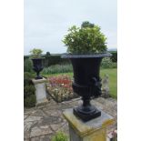 A pair of 18th century design bronze garden urns with egg and dart rims, fluted bases on socle stems
