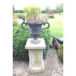 A pair of 19th century lead garden urns with cast classical design, each on socle base with egg