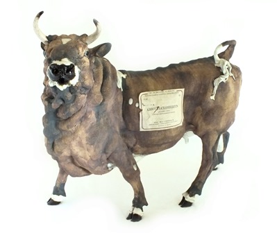 A bronze figure of a cow standing four square, it's head turned licking its back, green - Image 4 of 4