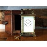 A 20th century Swiss & French brass repeating carriage clock, the enamel dial with Roman numerals,