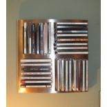 Four brushed stainless steel CD-wall racks and a large quantity of assorted CDs