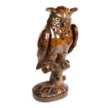A carved limewood figure of a long eared owl, Austrian 19th century, modelled perched on a tree