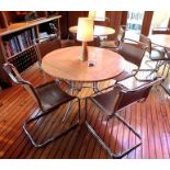 A maple veneer topped circular folding dining table, 1.06m diameter, together with a "Cadman" inlaid