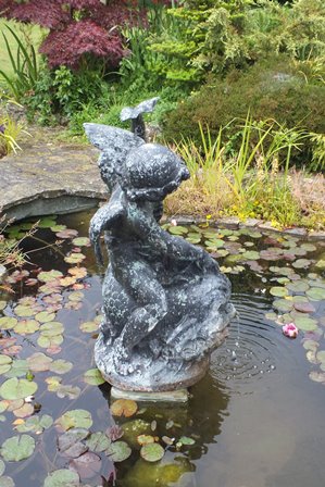 A 20th century bronze fountain figure in the form of a winged cherub riding on the back of an exotic - Image 2 of 4