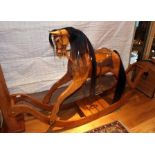 A stripped pine rocking horse on bow rocker base, with studded leather saddle and bridle, horse hair