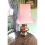 A pair of brass hexagonal baluster vase form table lamps on polished wood bases, complete with