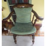 A Victorian fruitwood captain's chair, having swept crest rail over yoke arms, with turned ring