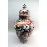 A large 20th century Japanese baluster vase and cover, painted in the Imari palette with panels of