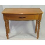 A contemporary craftsman made oak bow fronted side table, raised on barley twist supports, 1m