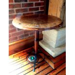 A late 20th century occasional table, disc inlaid flame veneered top, on ring turned stem, with