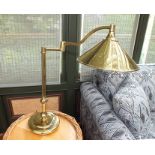 A pair of brass adjustable table top reading lamps