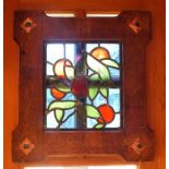 A 20th century leaded stained glass panel depicting red fruit amidst green leaves and briar