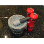 A granite pestle and mortar together with red pepper and salt mills (3)