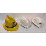 A yellow cork fireman's helmet with "London Fire Brigade" badge, inscribed in pen, "This is the