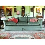 A pair of contemporary deep seated three seater sofas with loose cushion seats in pale green