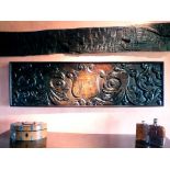 An early 17th century rectangular oak carved panel, dated 1615, with central shield cartouche