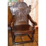 A mid 17th century Welsh oak elbow chair, the arched crest rail carved with opposing leaf scrolls