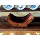 A late George III mahogany cheese coaster, the ring and baluster split moulded ends, on castors,