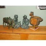 A pair of bronze patinated metal Asian inspired models of schoolboys, together with a carved