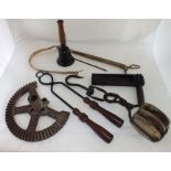 A metal and stained wood bird scarer, a hand bell, block and tackle, whip etc.