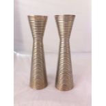 A set of three matching silver plated ribbed vases, 29.5cm high