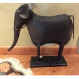 A 20th century welded sheet metal elephant figure, raised on rectangular base, 64cm high