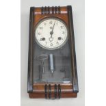 A Japanese Aichi Tokei Denki Art Deco style wall clock, walnut and ebonised cased, having glass door