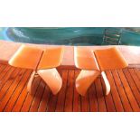 A pair of bentwood, possibly ash veneered, ply stools, designed by Sori Yanagi, with steel