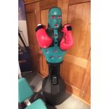 An electronic "Slam Man" boxing exerciser opponent, together with a pair of work-out gloves, with