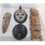 Four decorative West African masks with painted details